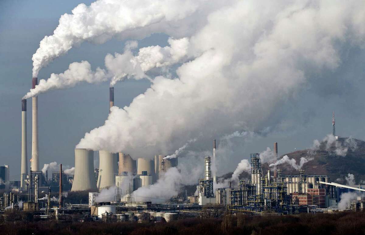FILE - In this Dec. 16, 2009 file photo, steam and smoke rises from a coal power station in Gelsenkirchen, Germany. Europe's main weapon in the battle against climate change is now fighting for its own survival. In early January, investors in the continent's cap-and-trade system still had to pay some euro14 ($18.30) for the right to emit one ton of carbon dioxide into the air. By last week, the price of one emission allowance had tumbled to a meager euro6.41, making it much cheaper to pollute and slashing the financial incentives for companies to invest in low-carbon technologies. (AP Photo/Martin Meissner, File)