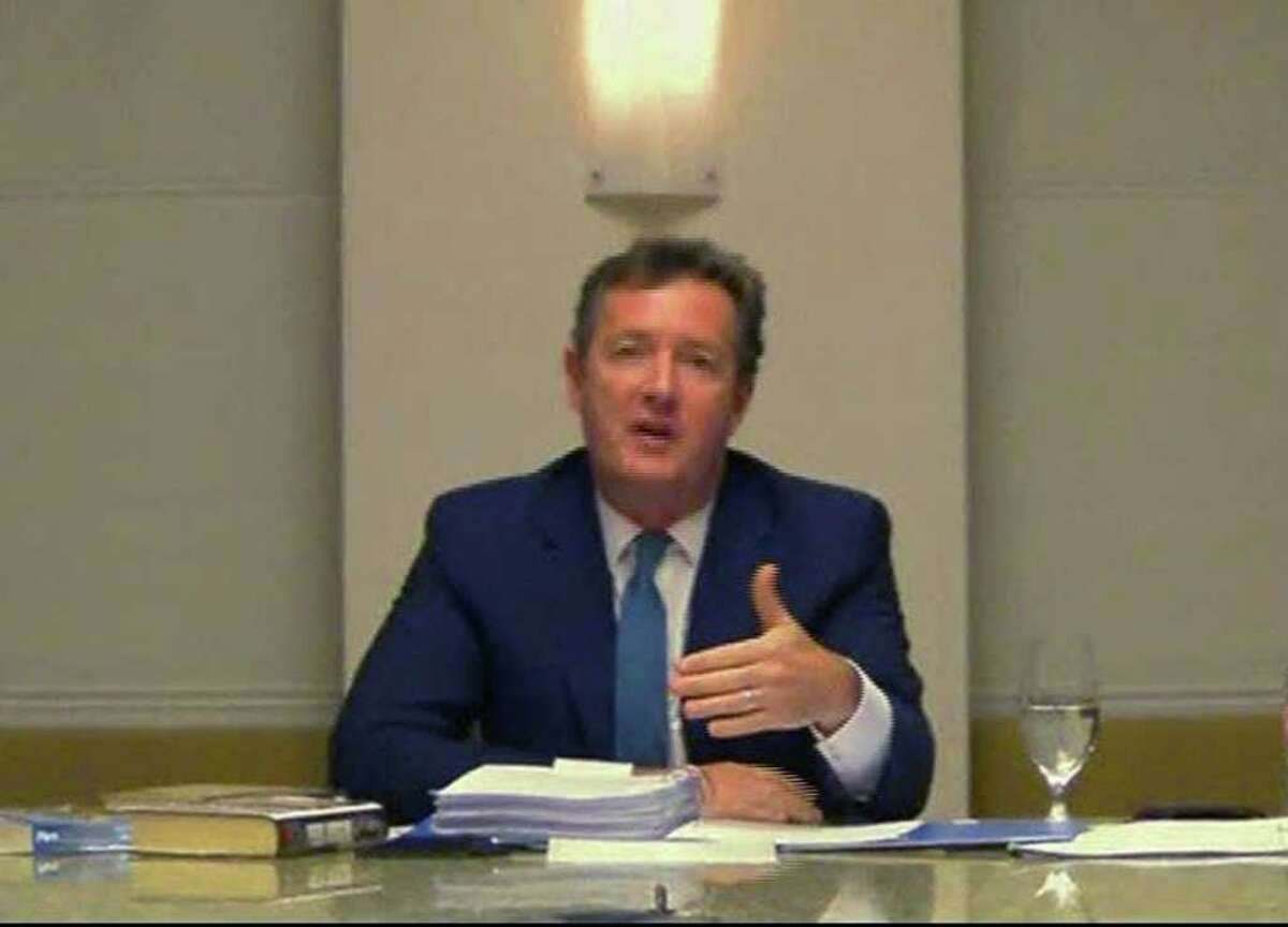ASSOCIATED PRESS ON THE SPOT: CNN interviewer Piers Morgan answers questions Tuesday from a media ethics inquiry sitting in London about his time at the top of Britain's tabloid industry.