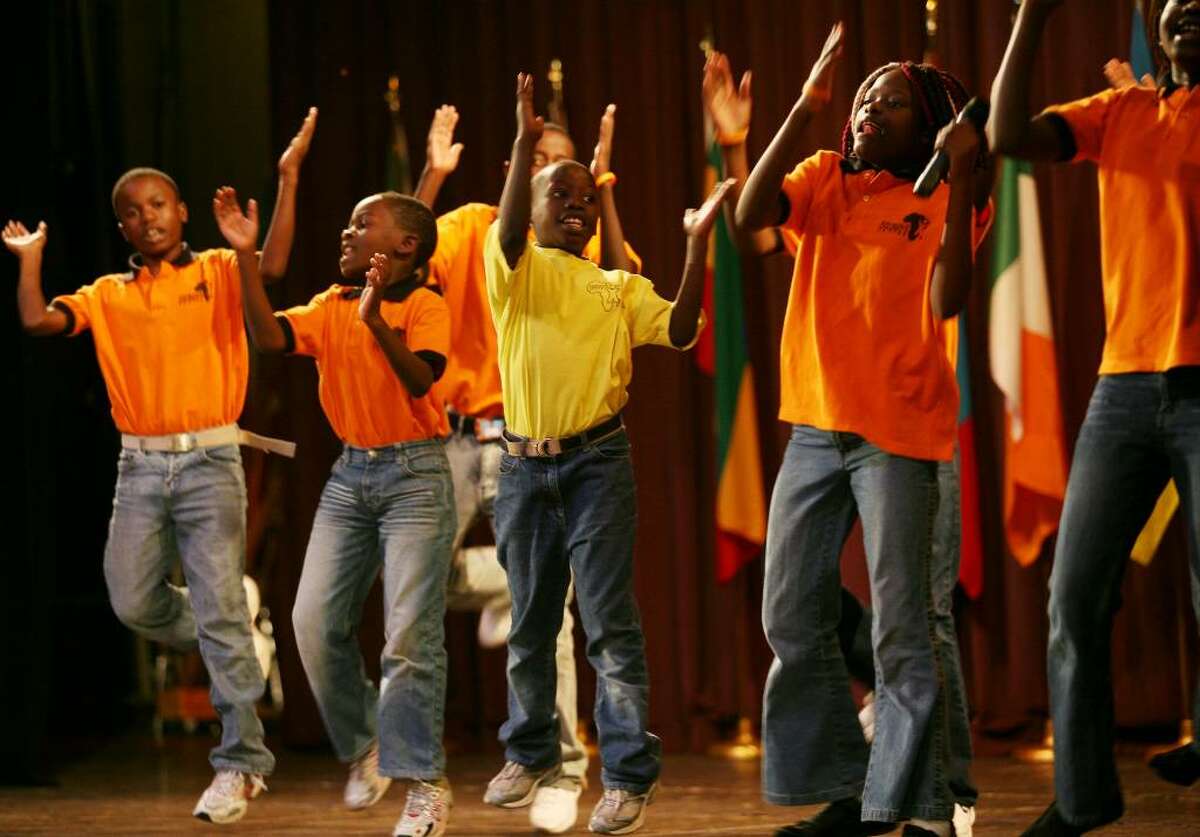 The Destiny Africa Children's Choir perform at the Mertens Theatre at the University of Bridgeport in Bridgeport, Conn. on Thursday, October 22, 2009. From left are choir members Geoffrey Ndugwa, 11, Haslam Makumbi, 11, Paul Ssekiwunga, 10, and Maria-Monica Nassoka, 11.