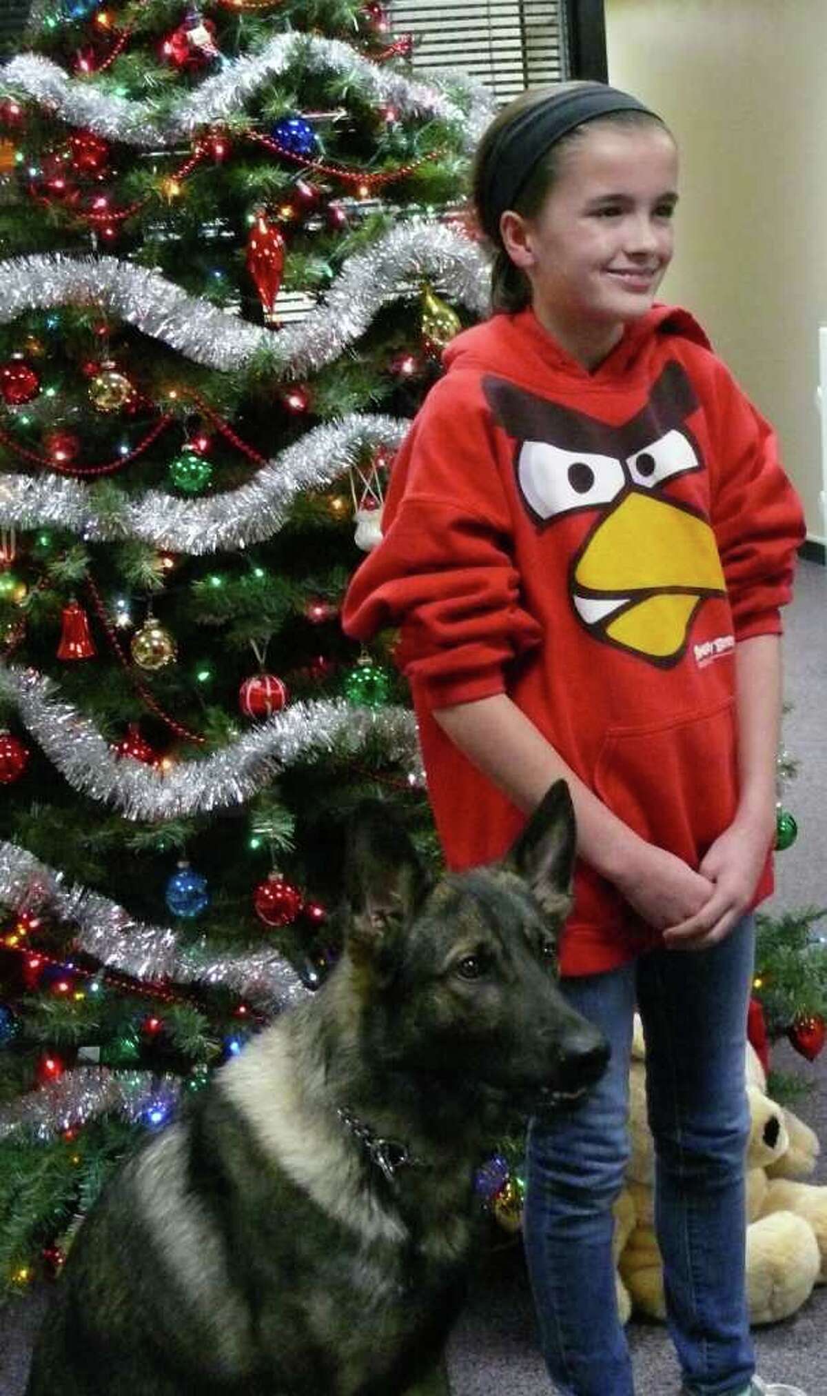 Margaret O'Connell poses with Fairfield's police dog, Ruger, after making a $700 donation to the K9 unit.