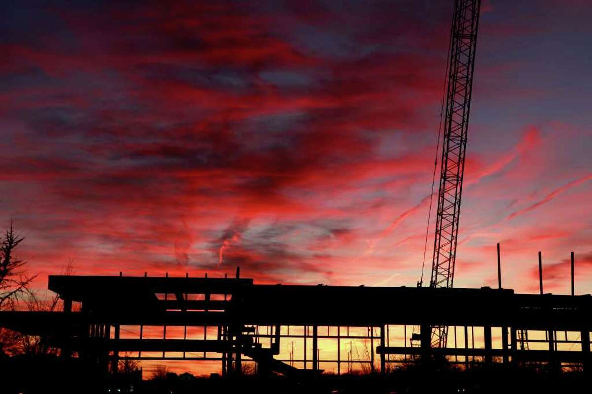 JACQUELINE LARMA: ASSOCIATED PRESS CONSTRUCTION: A commercial construction project is seen at sunset in Bala Cynwyd, Pa. The U.S. economy is ending 2011 on a roll. Fourth-quarter growth likely accelerated to the fastest pace since mid-2010.