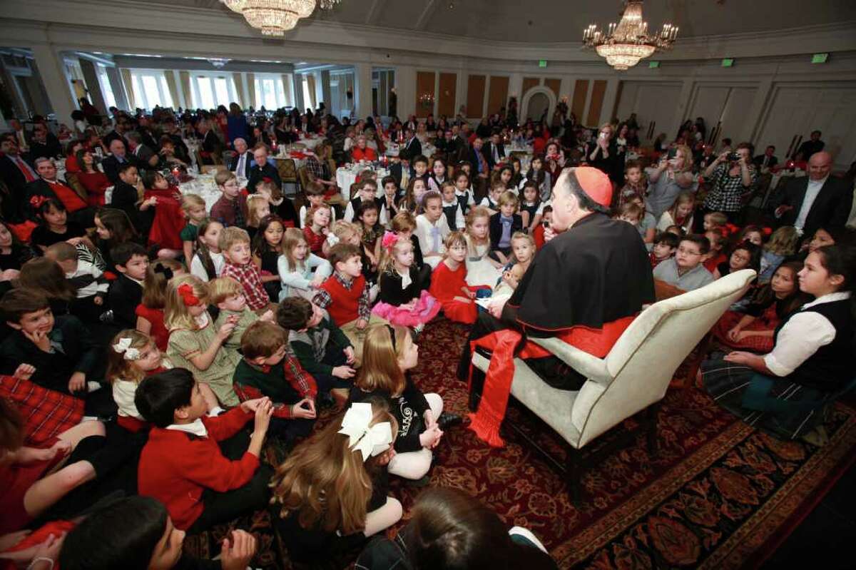 MICHAEL MARTINEZ PHOTOS Cardinal Daniel DiNardo shared a Christmas story with children during A Cardinal's Christmas luncheon at River Oaks Country Club.