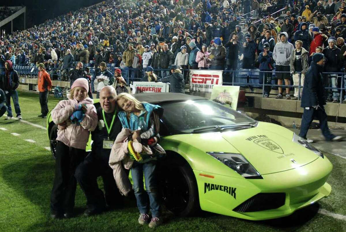 This hand out photo provded on Wednesday Dec. 21, 2011 by Maverik shows David Dopp, 34, of Santaquin, Utah, posing for a photo with his daughters Shayla, left, and Olivia, right, after winning a Lamborghini on Nov.12, 2011 in Maverik's Sweepstakes at Brigham Young University's LaVell Edwards Stadium in Provo, Utah. Dopp crashed the $380,000 sports car six hours after he got it. (AP Photo/Maverik, Kyle Buhler)