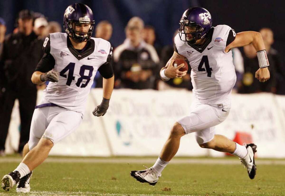 TCU quarterback Casey Pachall scrambles for a first down against Louisiana Tech as he follows fullback Luke Shivers during the first half of the Poinsettia Bowl NCAA college football game Wednesday, Dec. 21, 2011, in San Diego.