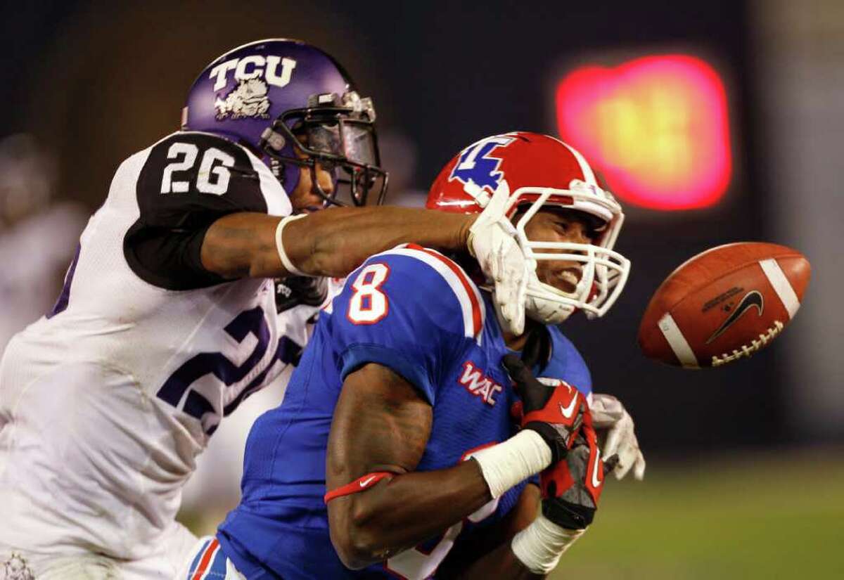 LENNY IGNELZI: ASSOCIATED PRESS TOO HOT TOO HANDLE: Louisiana Tech receiver Jacarri Jackson, right, can't hang on to a pass as TCU safety Devin Johnson hits him during first-half play in the Poinsettia Bowl.