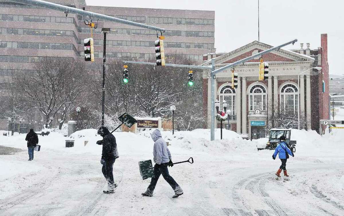 Pedestrians and plows occupied the streets Wednesday morning in downtown Stamford.