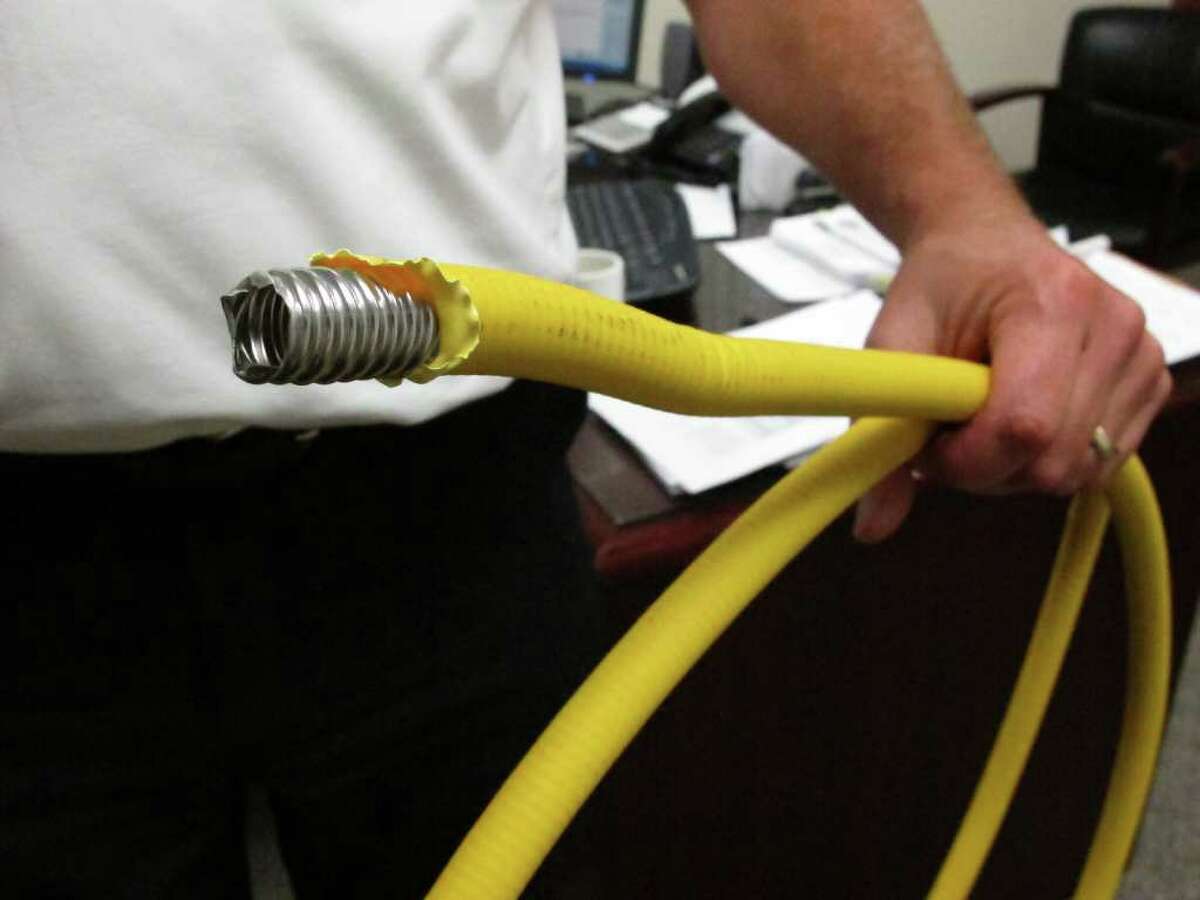 Genoa Township Fire Chief Gary Honeycutt holds corrugated stainless steel tubing, or CSST, at his office near Westerville, Ohio, on Thursday, Sept. 8, 2011. Reports of lightning-related fires and gas leaks in at least a dozen states have sparked concerns about the use of the flexible tubing for gas lines. (AP Photo/Kantele Franko)