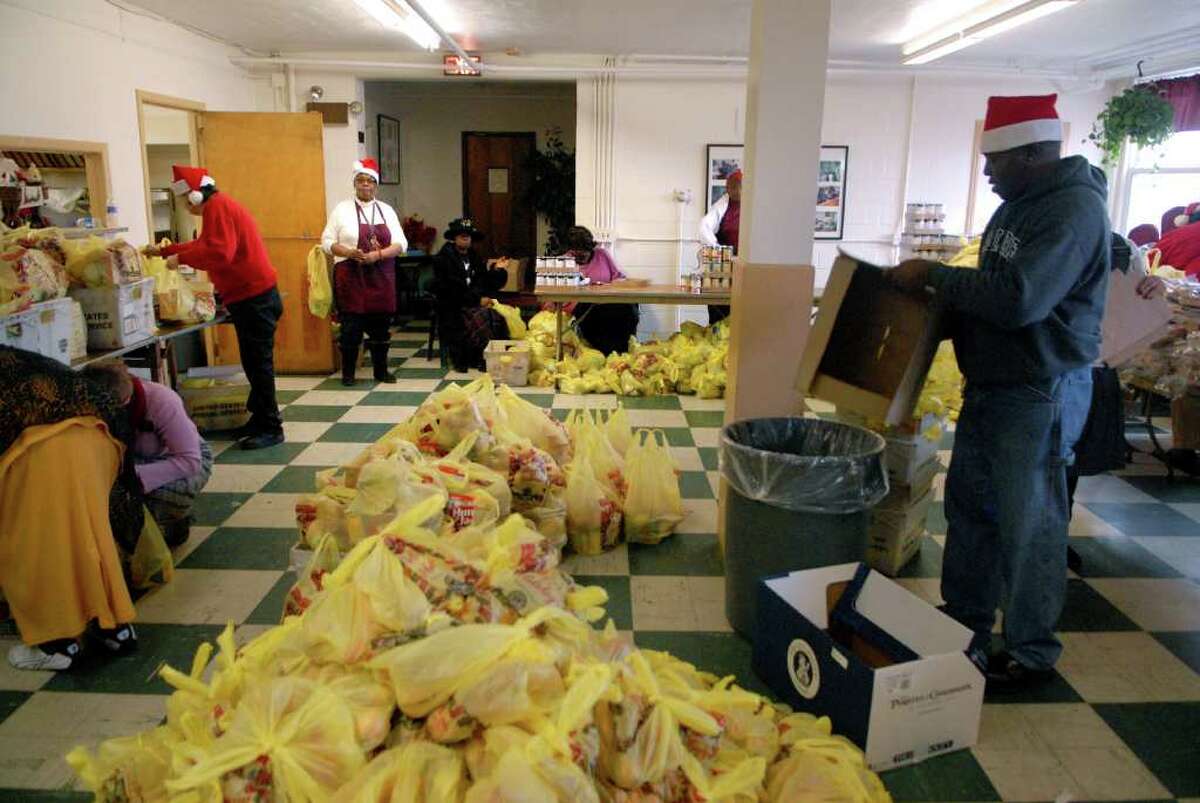 Volunteers get ready to open the 164 Wilson Food Pantry on Richmond Hill Ave in Stamford, Conn. on Thursday December 22, 2011.