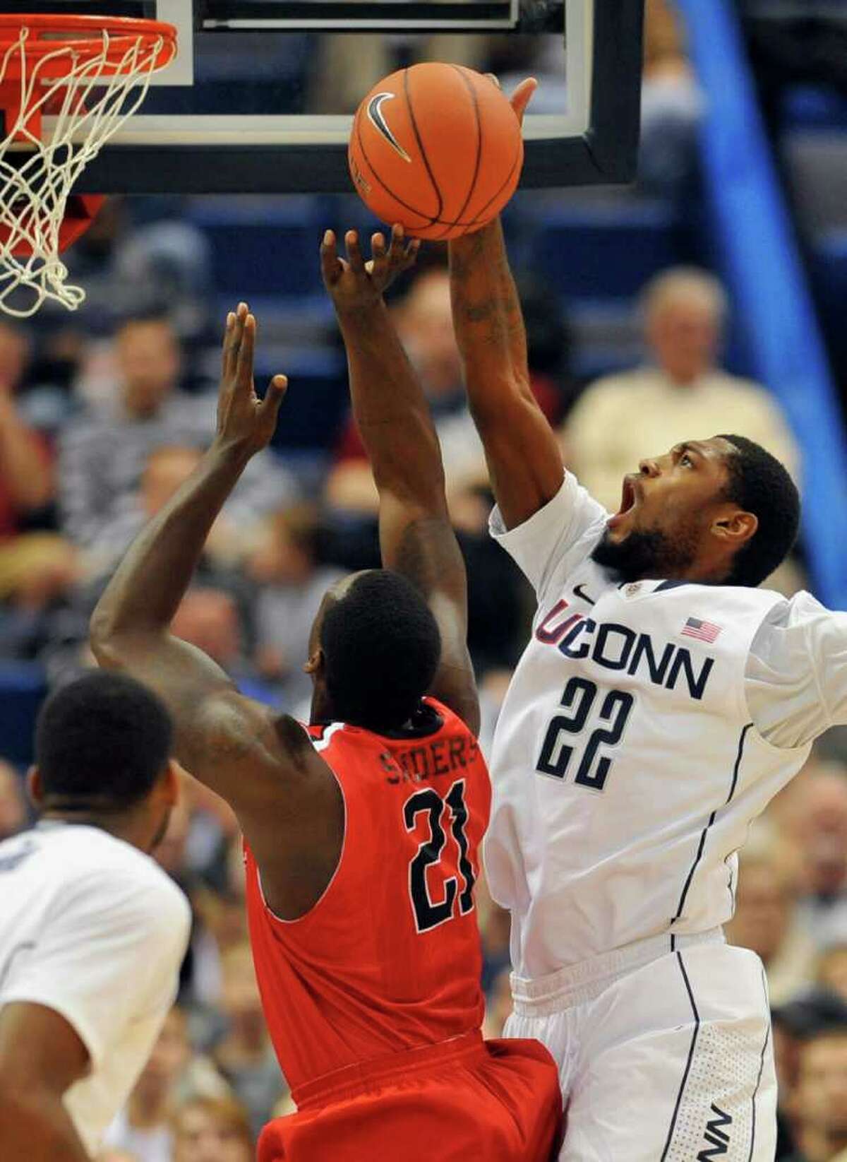 Connecticut's Roscoe Smith (22) blocks a shot from Fairfield's Rakim Sanders, left, in the first half of an NCAA college basketball game in Hartford, Conn., Thursday, Dec. 22, 2011. (AP Photo/Jessica Hill)