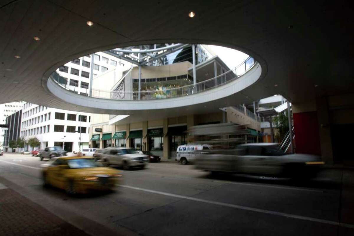 Cars drive under the Houston Pavilions downtown Friday, Feb. 6, 2009, in Houston. Many of the spaces in the Pavilions still stand empty. The bowling alley and entertainment facility, Lucky Strike was supposed open, but the project is now on hold. ( Johnny Hanson / Chronicle )