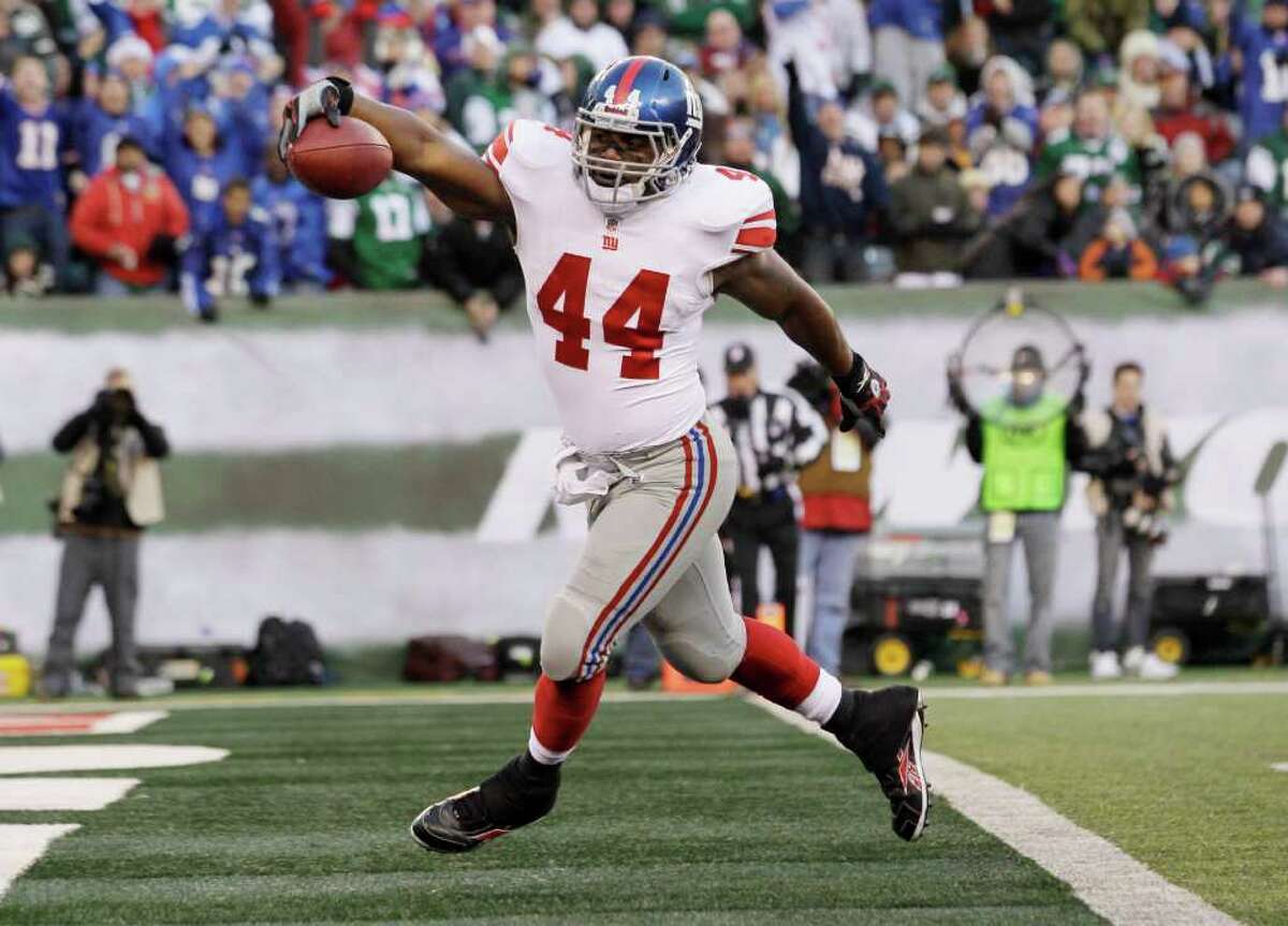New York Giants' Ahmad Bradshaw steps in to the end zone to score a touchdown during the third quarter of an NFL football game against the New York Jets, Saturday, Dec. 24, 2011, in East Rutherford, N.J.