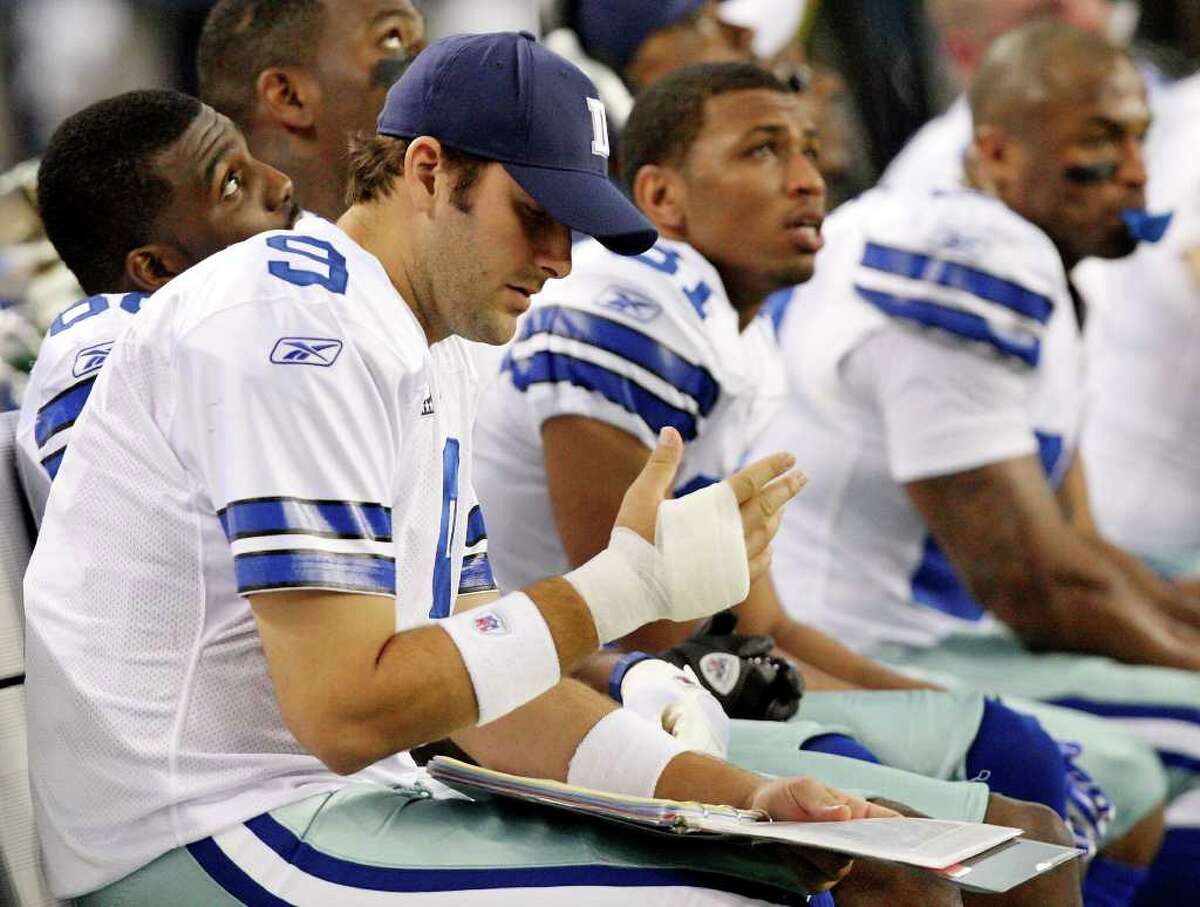 Dallas Cowboys' Tony Romo looks at his injured right hand while sitting on the bench during first half action against the Eagles Saturday Dec. 24, 2011 at Cowboys Stadium in Arlington, TX. PHOTO BY EDWARD A. ORNELAS/eaornelas@express-news.net)