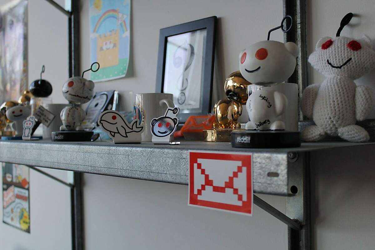 Posters, toys, and bobblehead dolls featuring Reddit.com's alien mascot line the walls at Reddit's main offices in San Francisco.