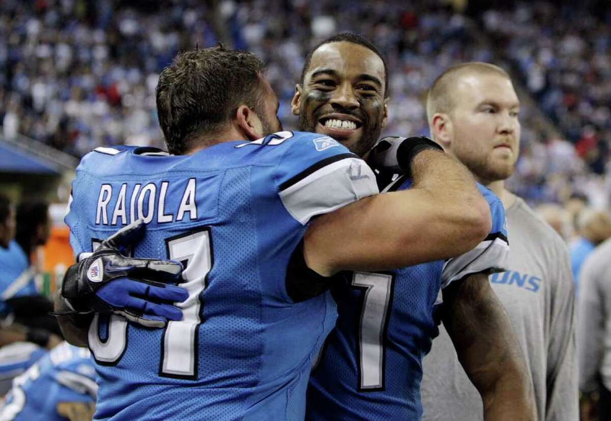Detroit Lions center Dominic Raiola (51) hugs teammate wide receiver Calvin Johnson during the closing minutes of an NFL football game against the San Diego Chargers in Detroit, Saturday, Dec. 24, 2011. The Lions clinched a playoff spot with their 38-10 win. (AP Photo/Carlos Osorio)