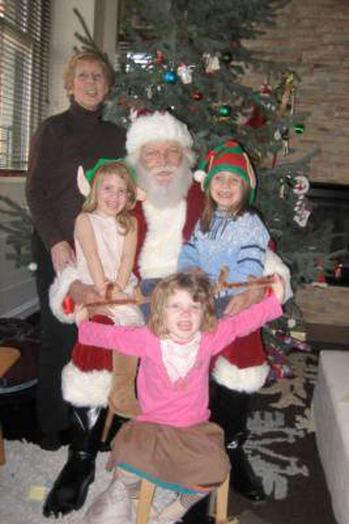 Courtesy of the Johnson family A photograph taken from the Web site gigmasters.com showing the five victims from Sunday's fire: Lomer Johnson, dressed as Santa; his wife, Pauline; and their granddaughters, Sarah, Grace, and Lily, left to right.