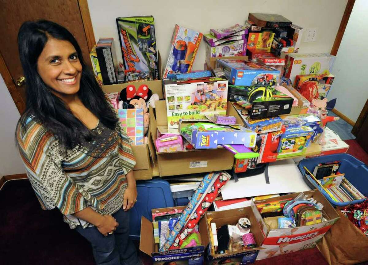 Fazana Saleem-Ismail stands in her basement full of party supplies and toys for homeless children on Friday, Dec. 23, 2011 in Schenectady, N.Y. (Lori Van Buren / Times Union)