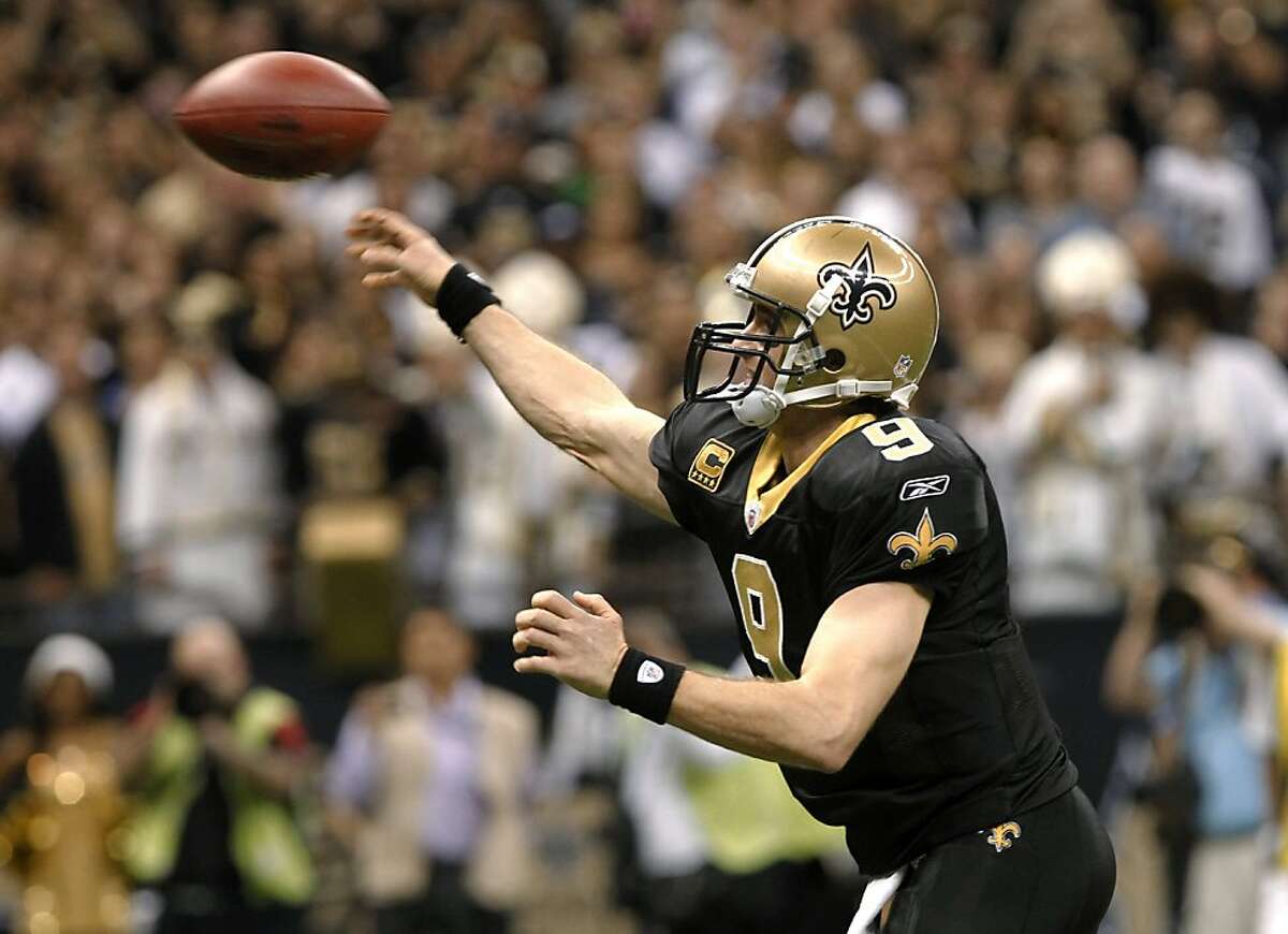 New Orleans Saints quarterback Drew Brees throws a touchdown pass during the fourth quarter of an NFL football game against the Atlanta Falcons in New Orleans, Monday, Dec. 26, 2011. With the pass, Brees set an NFL record for passing yardage in a season. (AP Photo/Rusty Costanza)