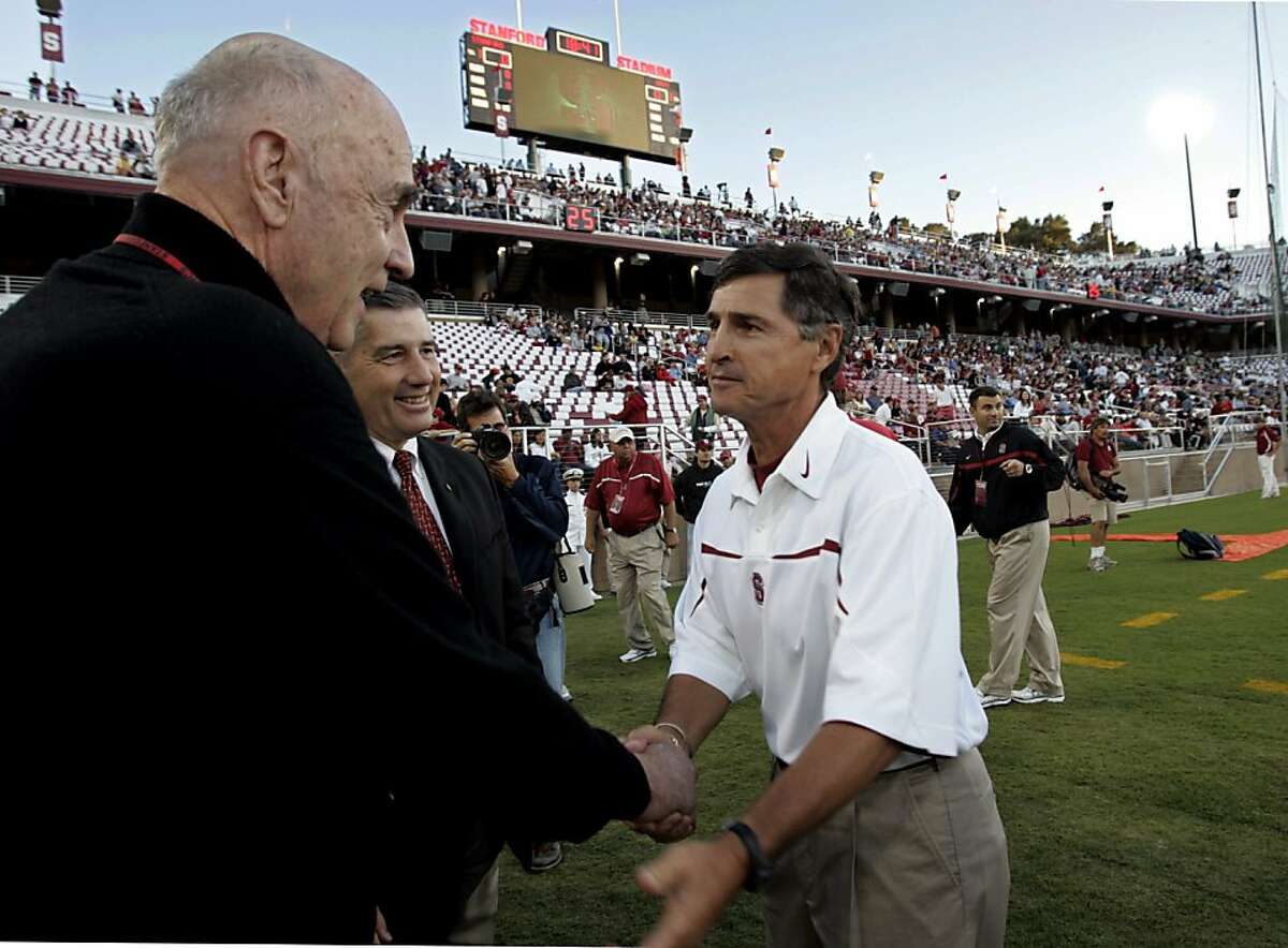 Stanford football coach Walt Harris, right, shakes hands with Stanford fan John Arrillaga, left, a developer, as new Stanford athletic director Bob Bowlsby, center, looks on in Stanford's newly renovated stadium before Stanford's college football game against Navy, Saturday, Sept. 16, 2006, in Stanford, Calif. Arrillaga help pay for the new stadium. (AP Photo/Paul Sakuma)