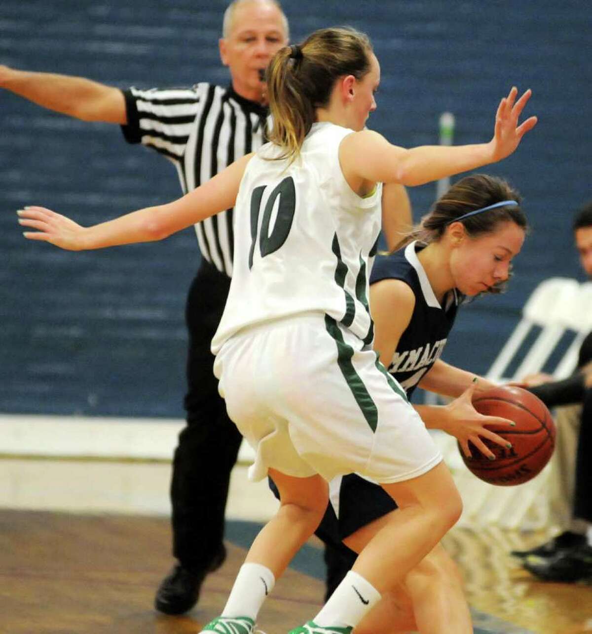 New Milford High School's, Jessica Noteware, plays defense while Immaculate High school's, Emily Fredette, has possession of the ball during the 2011 7th Annual Girls Holiday Festival at the Danbury War Memorial on Tuesday, Dec. 27.