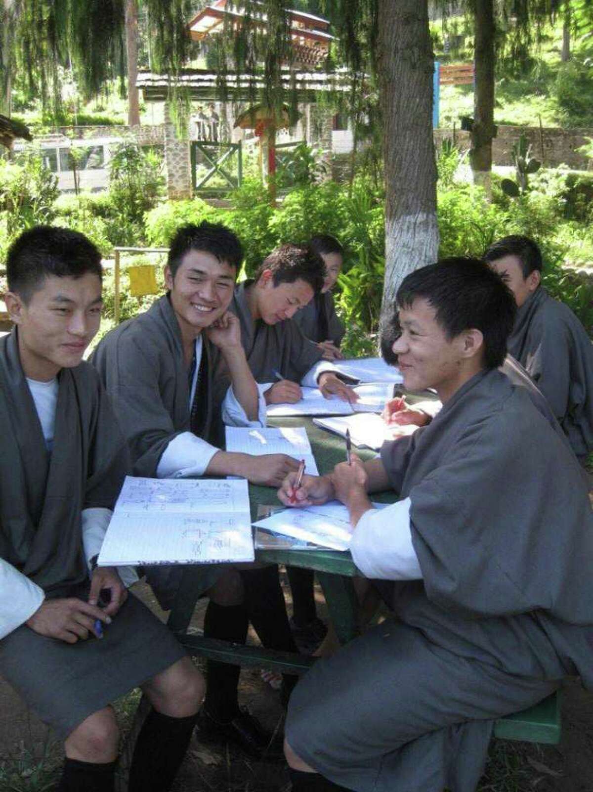 Trav Bhutan 2 Bhutanese high school students are all smiles as they work. Bhutan is said to be the happiest place on earth.