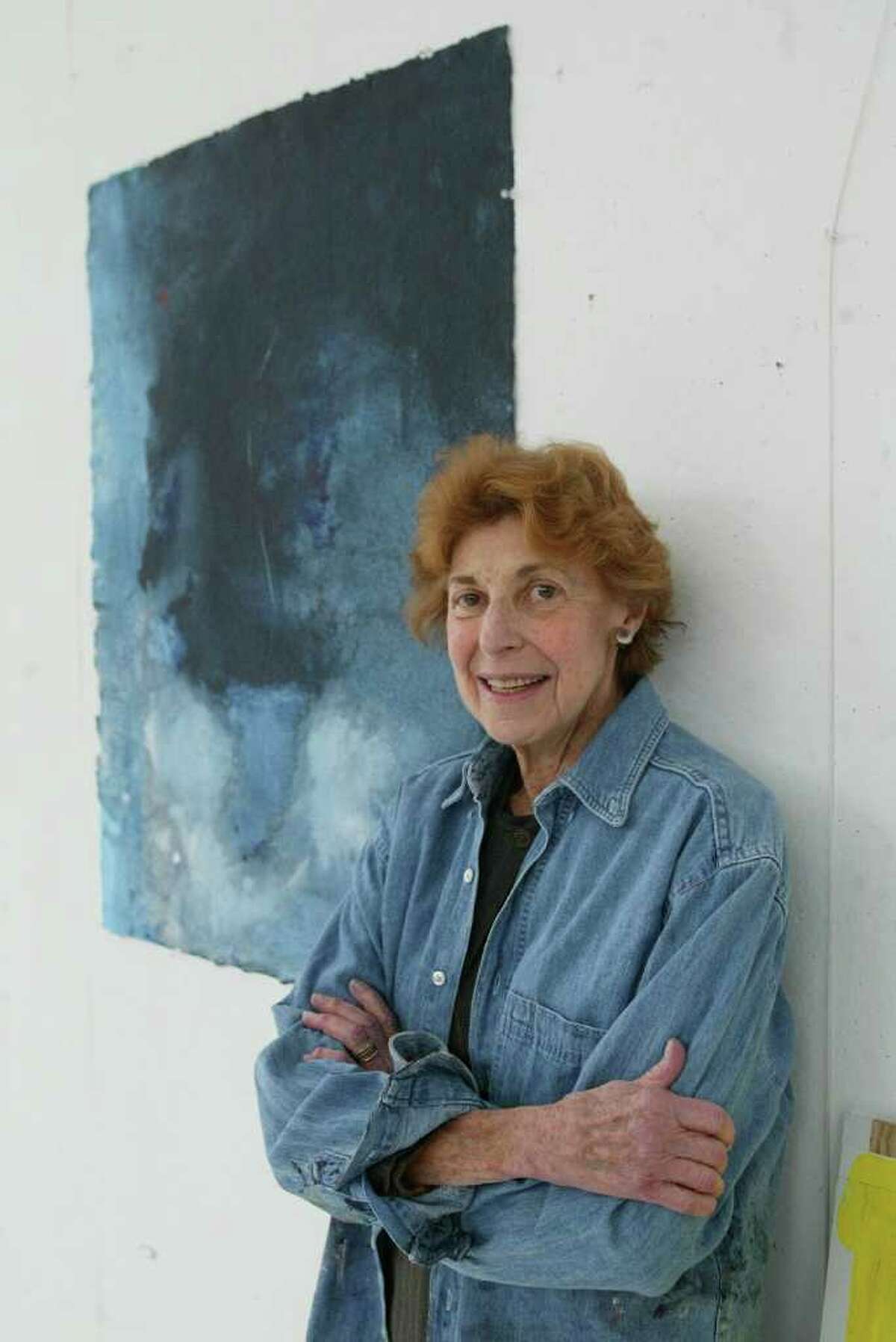 FILE -- The artist Helen Frankenthaler with her work, "Blue Lady," an acrylic on paper, in her studio on Contentment Island in Darien, Conn., April 8, 2003. Frankenthaler, the lyrically abstract painter whose technique of staining pigment into raw canvas helped shape an influential art movement in the mid-20th century, died on Tuesday, Dec. 27, 2011, at her home in Darien. She was 83. (Suzanne DeChillo/The New York Times)