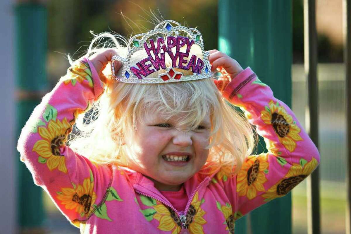 Evie Smith, 3, adjusts a New Year's Eve tiara she got the night before while playing at the River Oaks Elementary's SPARK.