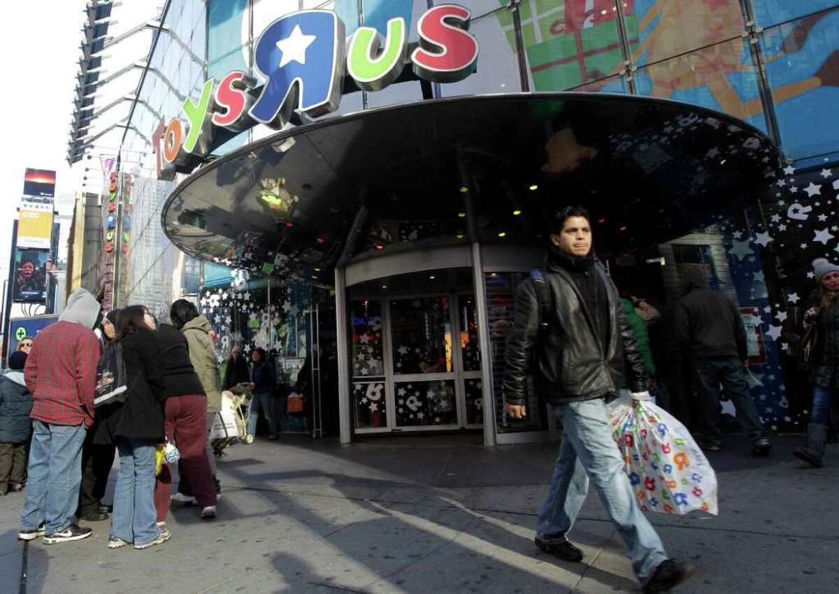 FILE - In this Dec. 24, 2011 file photo, a last-minute shopper leaves the Toys R Us flagship store in New York's Times Square. A mall trade group said Wednesday, Dec. 28, 2011, that last minute shoppers gave merchants a solid lift during the final week before Christmas. (AP Photo/Mary Altaffer, File)
