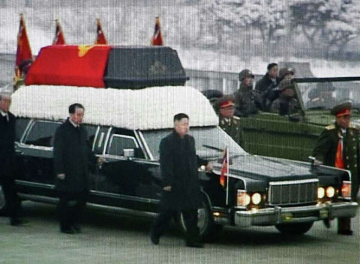 In this image made from KRT video, Kim Jong Un, center, Kim Jong Il's youngest son and successor, walks next to his father's hearse during a funeral procession for the late North Korean leader in Pyongyang, North Korea Wednesday, Dec. 28, 2011. (AP Photo/KRT via APTN) TV OUT, NORTH KOREA OUT