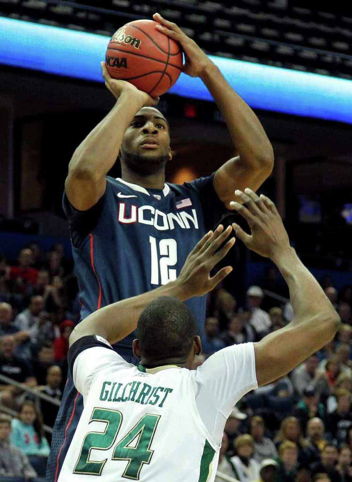 Connecticut center Andre Drummond (12) shoots over South Florida forward Augustus Gilchrist (24) during the first half of an NCAA college basketball game Wednesday Dec. 28, 2011, in Tampa, Fla. (AP Photo/Chris O'Meara)