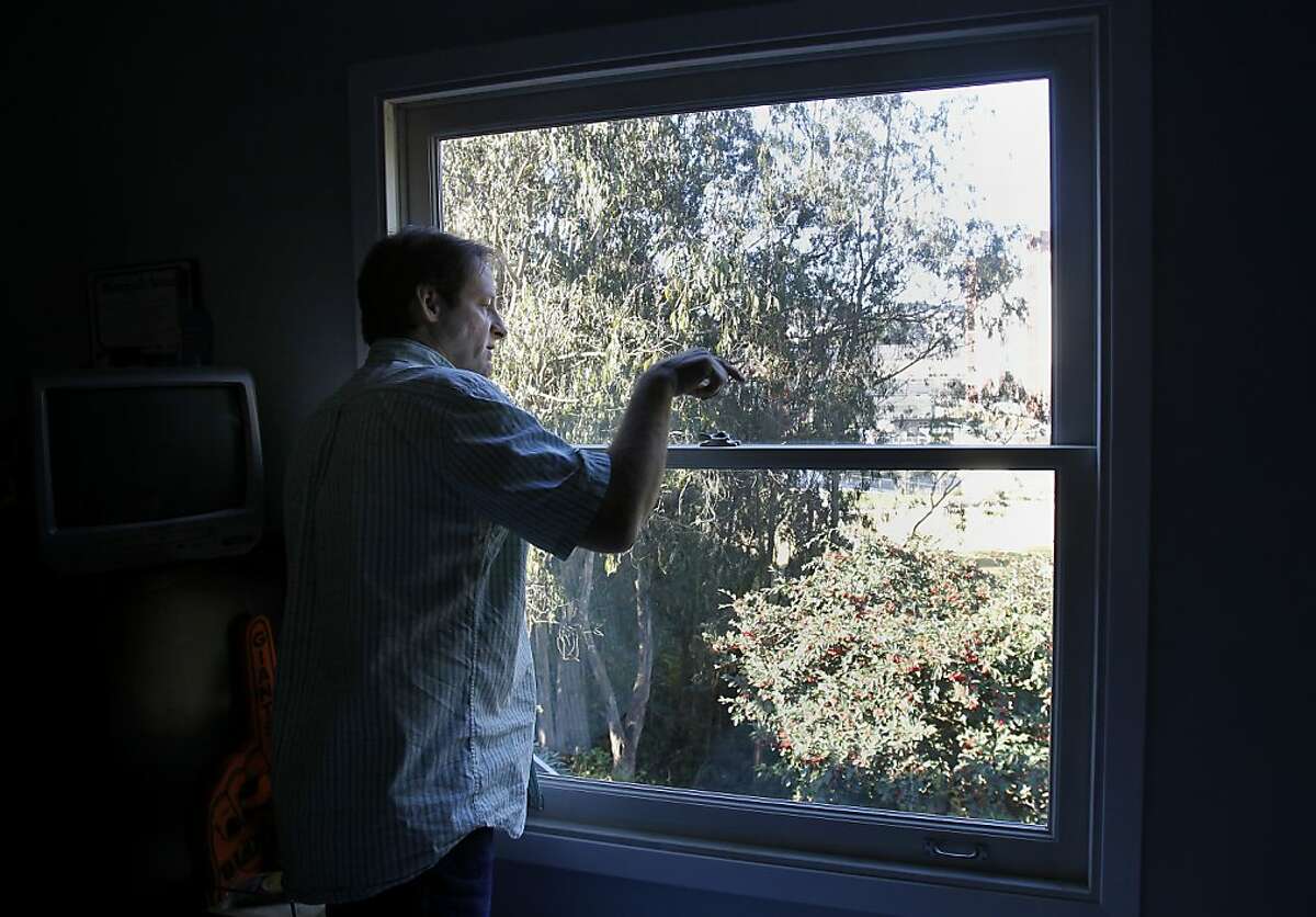 Terry Thompson looks out the window of his nephews room and complains about the noise and how it has scared the birds away. Terry Thompson and many of his neighbors are upset that the new Laguna Honda hospital in San Francisco, Calif. emits a loud hum, which he says is ruining the quality of life of the neighborhood.