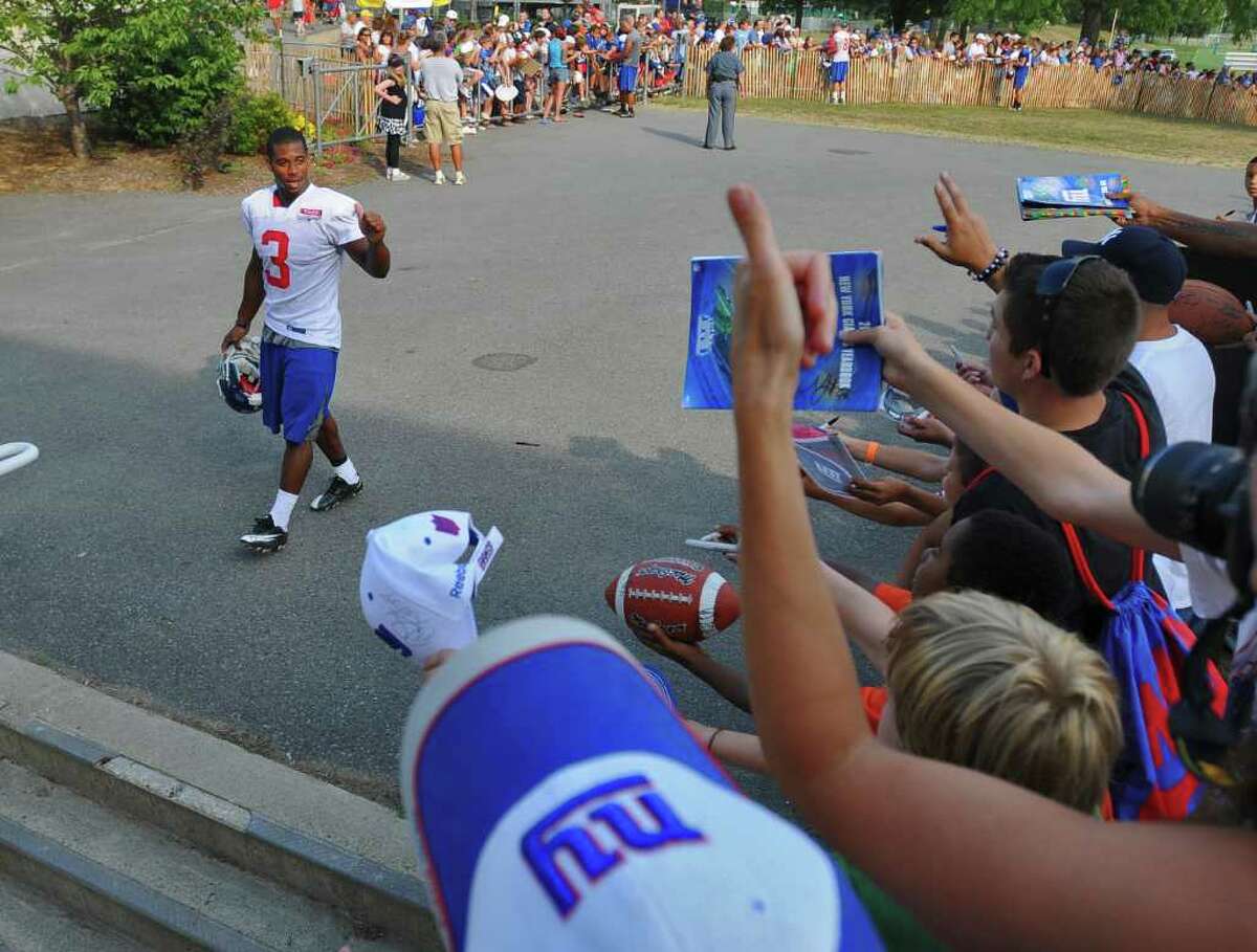 New York Giants wide receiver Victor Cruz waves to fans as he heads to the locker room after signing autographs after practice at UAlbany in Albany, NY at training camp on Thursday afternoon August 19, 2010. ( Philip Kamrass / Times Union archive)