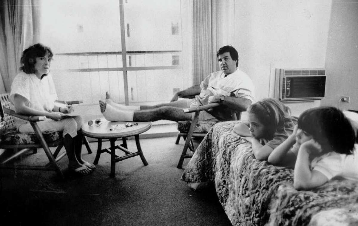 PUERTO RICO - JANUARY 01: Survivors Joan and John Benevento, who injured his feet jumping through casino window, and Chandra, 10, and Brandon, 7, of Woodbridge, Conn., are together in hotel room after four hours of serparation during blaze that killed 95 at the Dupont Plaza Hotel.. (Photo by Misha Erwitt/NY Daily News Archive via Getty Images)