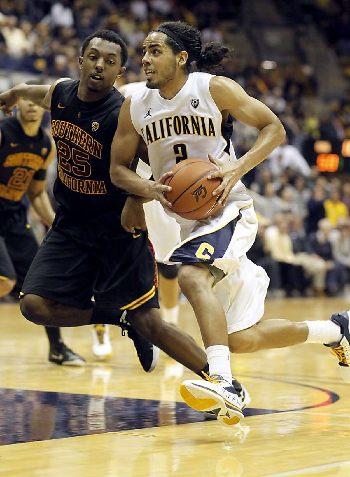Cal's Jorge Gutierrez, (2) dtrives past, USC's Byron Wesley, (25) in the second half, as the California Golden Bears go on to beat the USC Trojans 53-49, at Haas Pavilion on the UC Berkeley campus on Thursday December 29, 2011 in Berkeley, Ca.