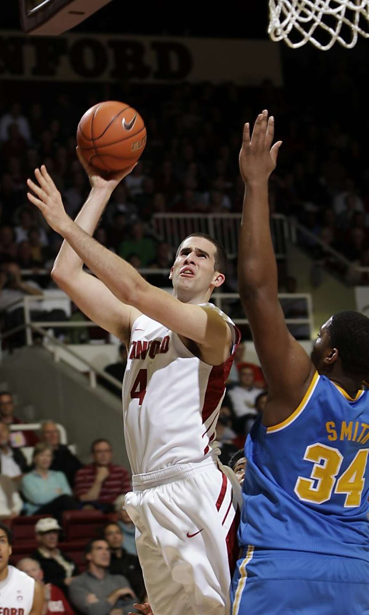 Stanford center Stefan Nastic (4) scores over UCLA center Joshua Smith (34) in the first half of an NCAA college basketball game in Stanford, Calif., Thursday, Dec. 29, 2011.