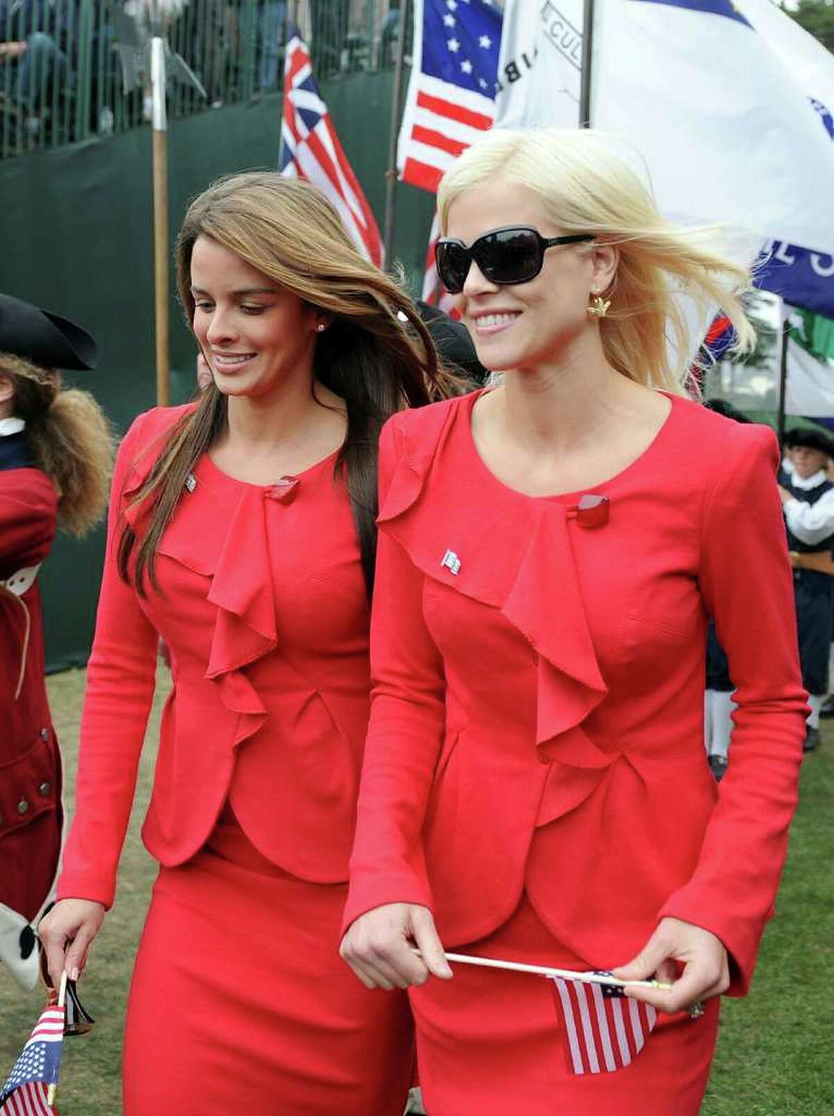 Elin Woods and Yvette Prieto make their way to their seats during Opening Ceremony of The Presidents Cup at Harding Park Golf Course on October 7, 2009 in San Francisco, California.