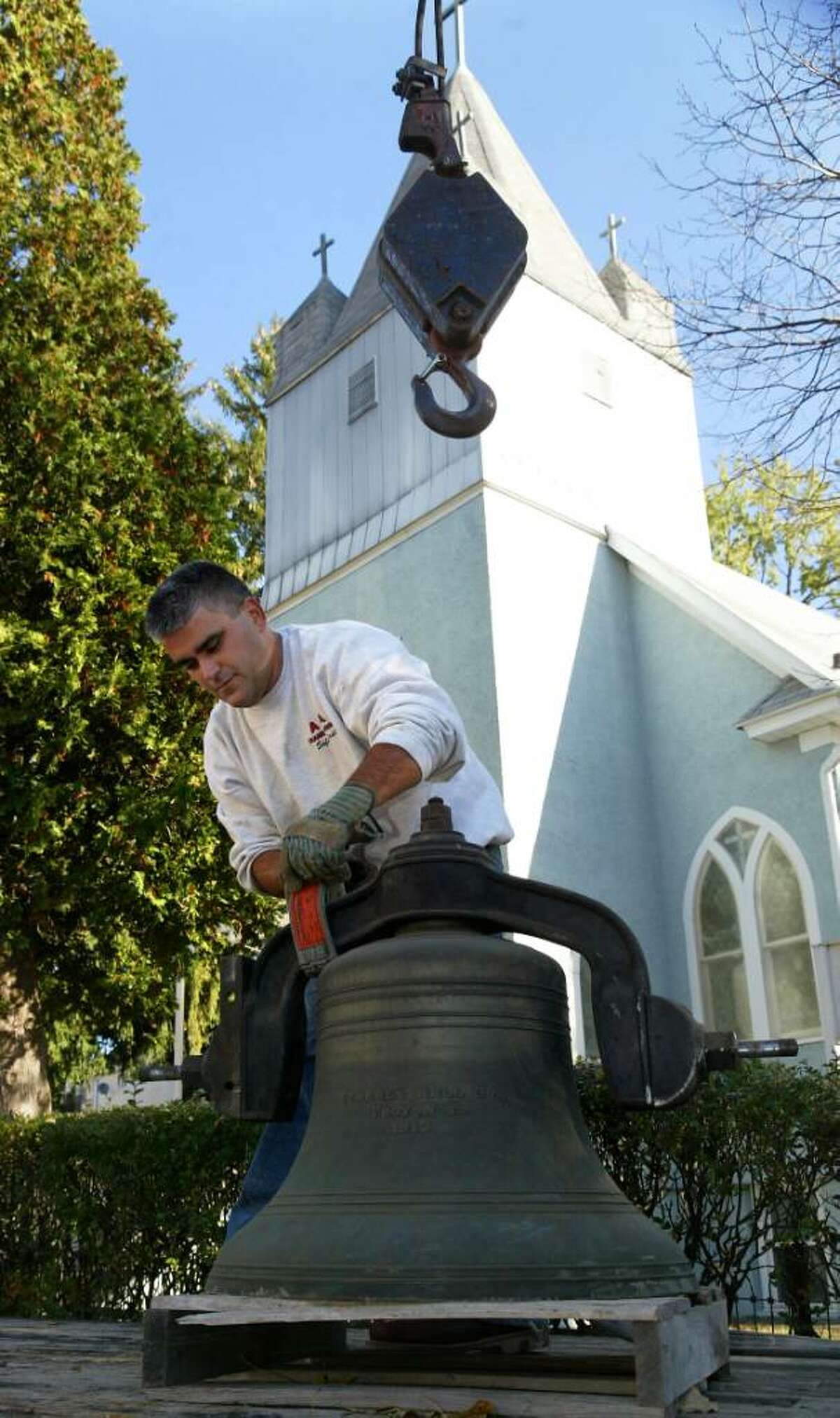 John Fernandes, of A & A Crane and Rigging in Bridgeport, unhooks the historic turn of the century church bell from his crane at Holy Trinity Greek Orthodox Church on Hubbell Avenue in Ansonia, Monday, Oct. 26, 2009.