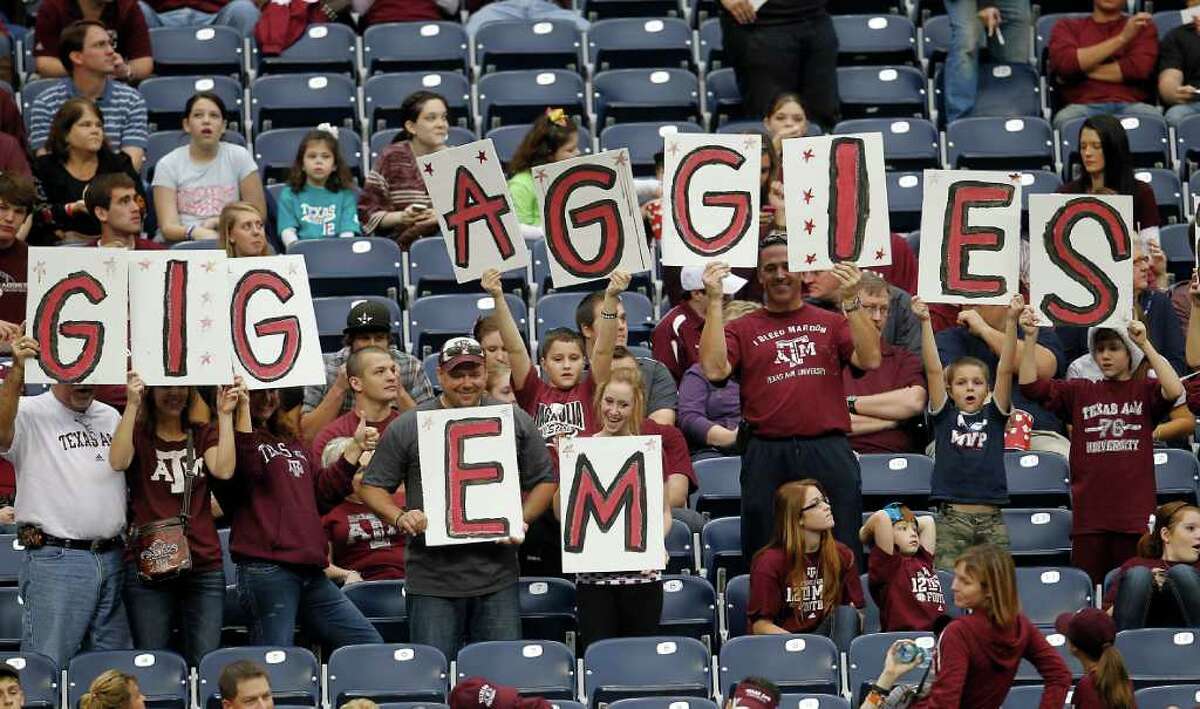 Texas A&M fans with signs before the start of the Meineke Car Care Bowl at Reliant Stadium,Saturday, Dec. 31, 2011, in Houston.