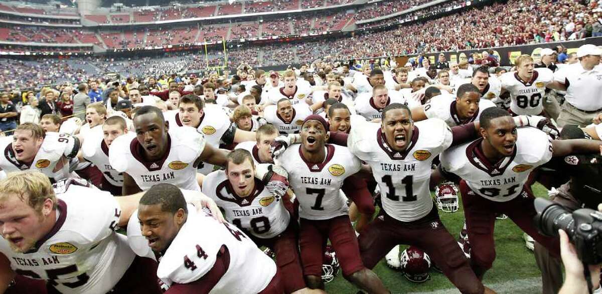 Texas A&M Aggies players celebrate after the Meineke Car Care Bowl at Reliant Stadium,Saturday, Dec. 31, 2011, in Houston. Texas A&M won the game against Northwestern University 33-22.