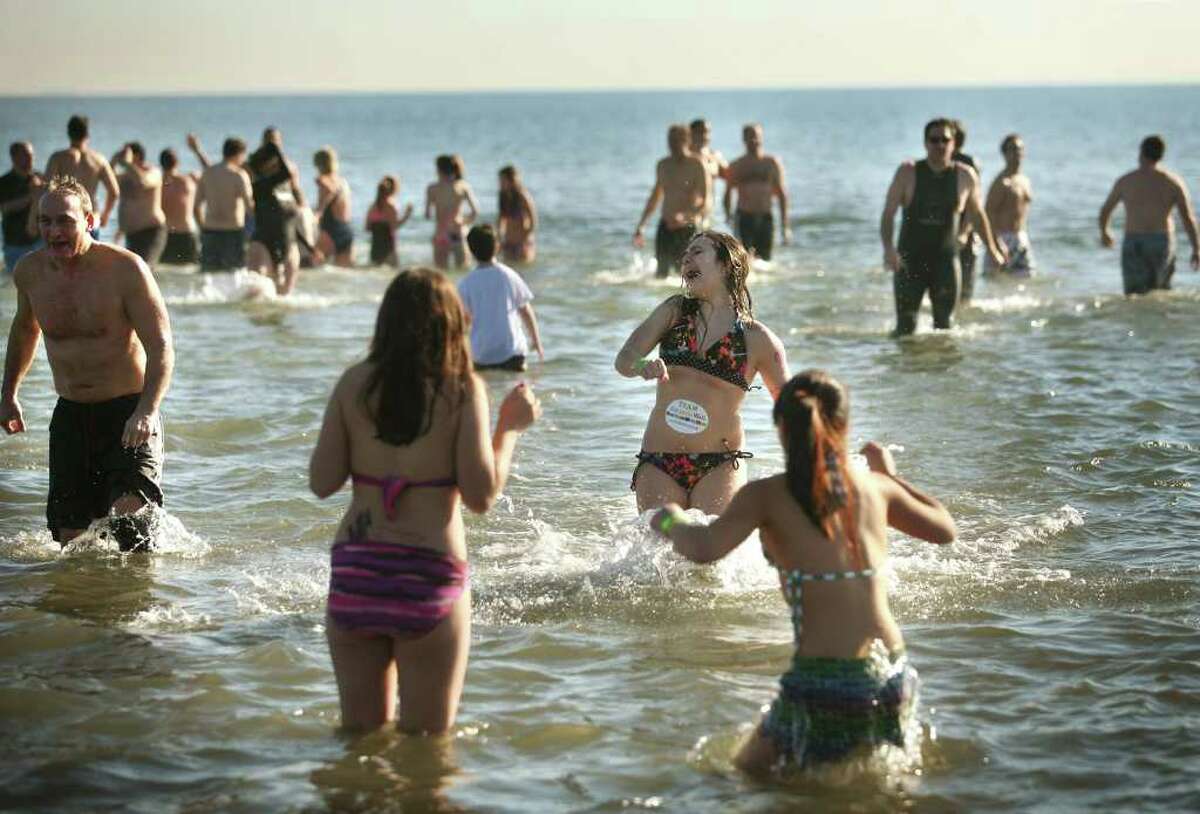 Participants brave the frigid waters of the Sound for the annual Polar Plunge at Compo Beach in Westport on Sunday, January 1, 2012. The event raised money for The Hole in the Wall Gang Camp.