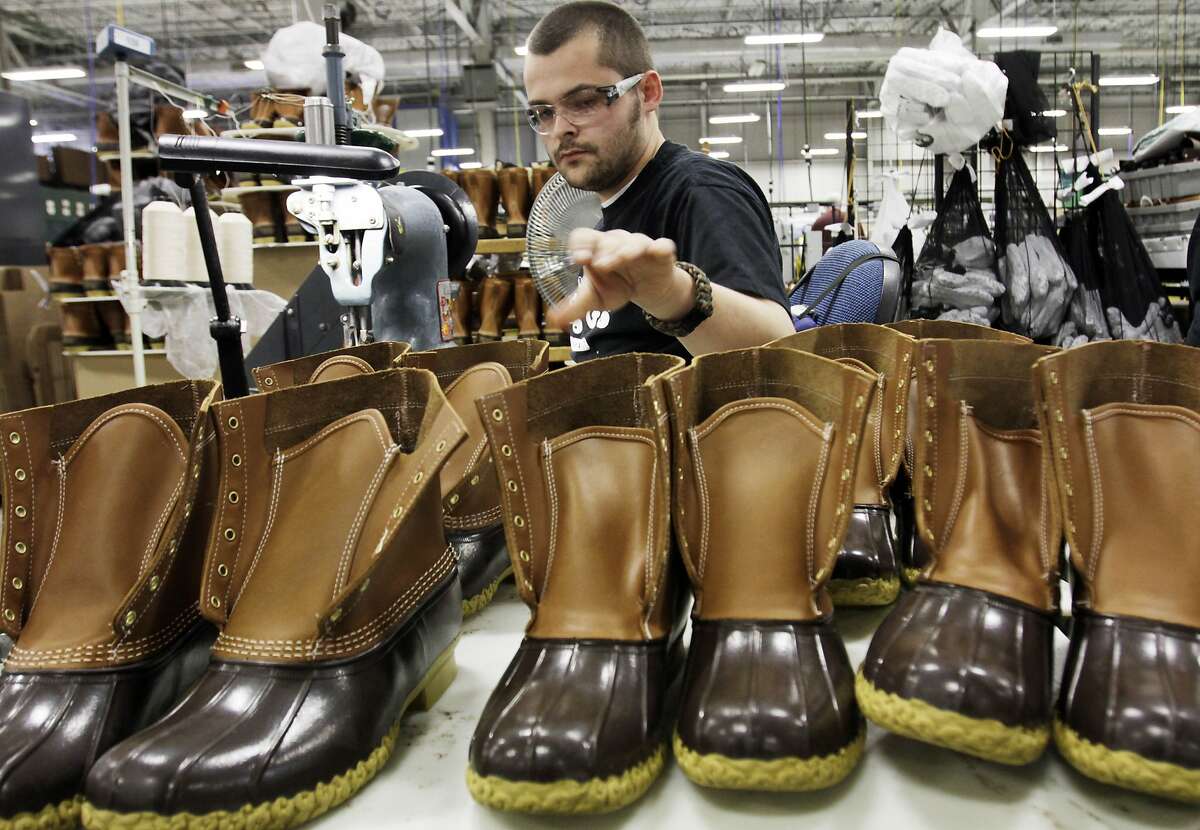 In this Dec. 14, 2011 photo, Eric Rego, of E. Boothbay, Maine, stitches boots in the facility where L.L. Bean boots are assembled in Brunswick, Maine. L.L. Bean's famed hunting boots are seeing a surge in popularity, necessitating the hiring of more than 100 additional employees to make them. (AP Photo/Pat Wellenbach)