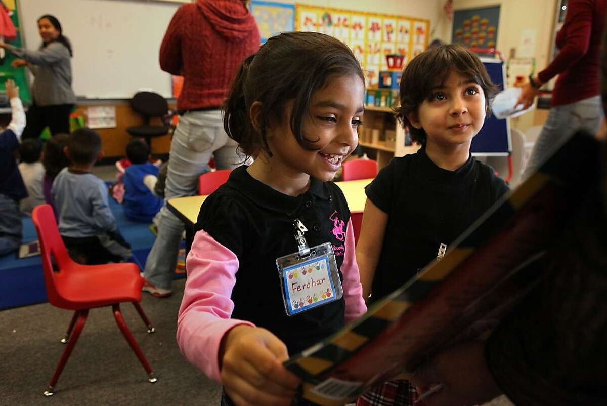 Ferohar Bellagh (left) and Sohaila Belagh (right), both four years old, at State preschool in Brier Elementary school in Fremont, Calif., looking at "The Clever Boy and the Terrible, Dangerous Animal" by Idries Shah from Hoopoe Books on Monday, November 14, 2011.