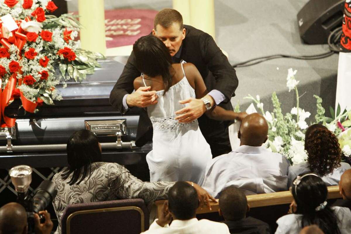 UConn football coach Randy Edsall hugs JoAngila Howard during the funeral for her son, Jasper Howard, Monday, Oct. 26, 2009 in Miami. Howard, a UConn football player, was fatally stabbed outside a dance on Connecticut's campus. (AP Photo/J Pat Carter)