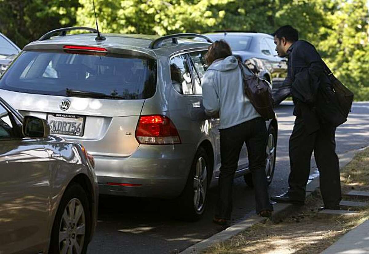 Commuters climb into a car at a casual carpool pickup location in Oakland, Calif., on Thursday, July 1, 2010. Thursday was the first day carpoolers were forced to pay a $2.50 toll to cross the Bay Bridge.