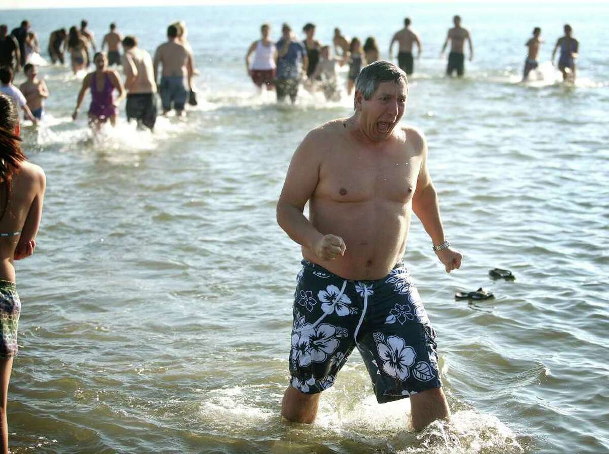 Jeffrey Busch of Wilton reacts to the frigid waters of the Sound during the annual Polar Plunge at Compo Beach in Westport on Sunday, January 1, 2012. The event raised money for The Hole in the Wall Gang Camp.
