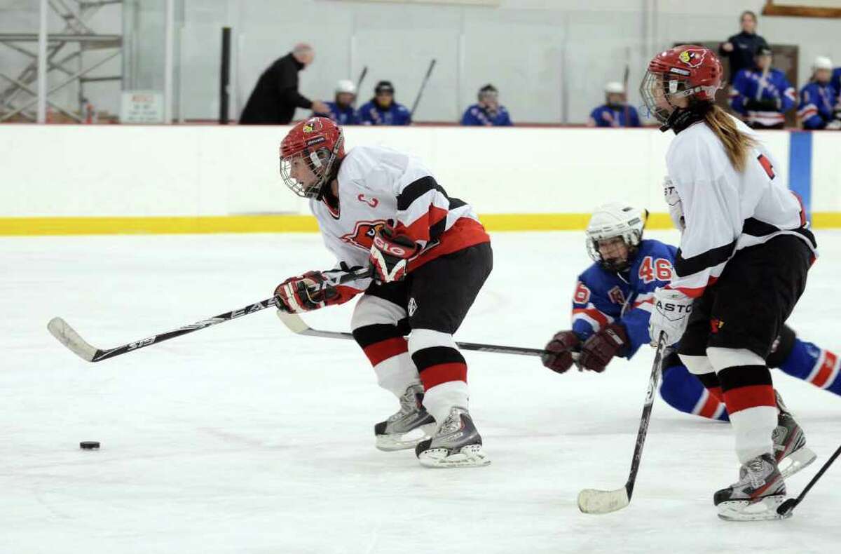 Greenwich's Meghan Spezzano (8) controls the puck as Fairfield's Anna Collimore (46) defends during the girls ice hockey game at Hamill Rink in Greenwich on Monday, Jan. 2, 2012.
