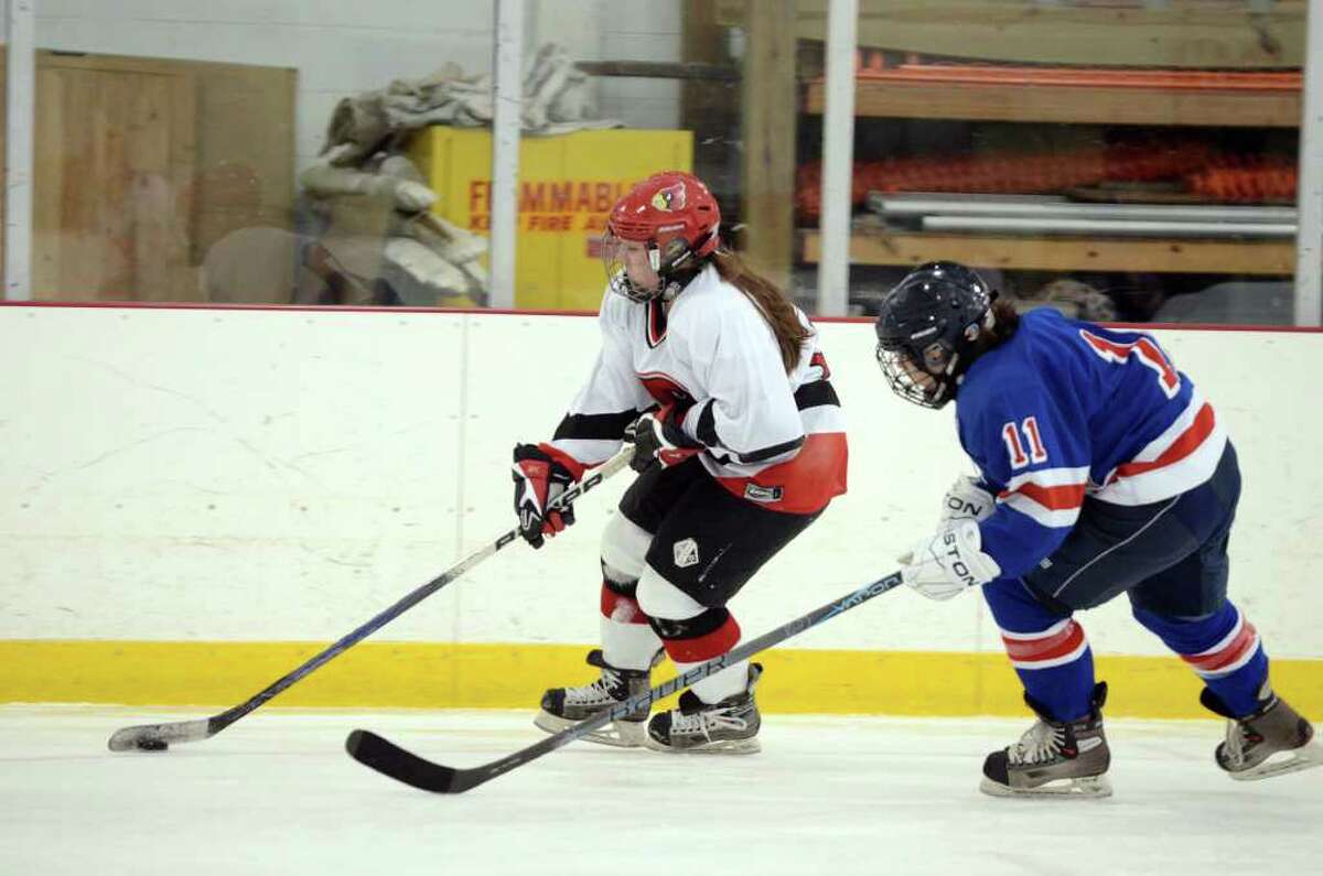 Greenwich's Erin Ferguson (20) controls the puck as Fairfield's Anniekaye Ficarra (11) defends during the girls ice hockey game at Hamill Rink in Greenwich on Monday, Jan. 2, 2012.