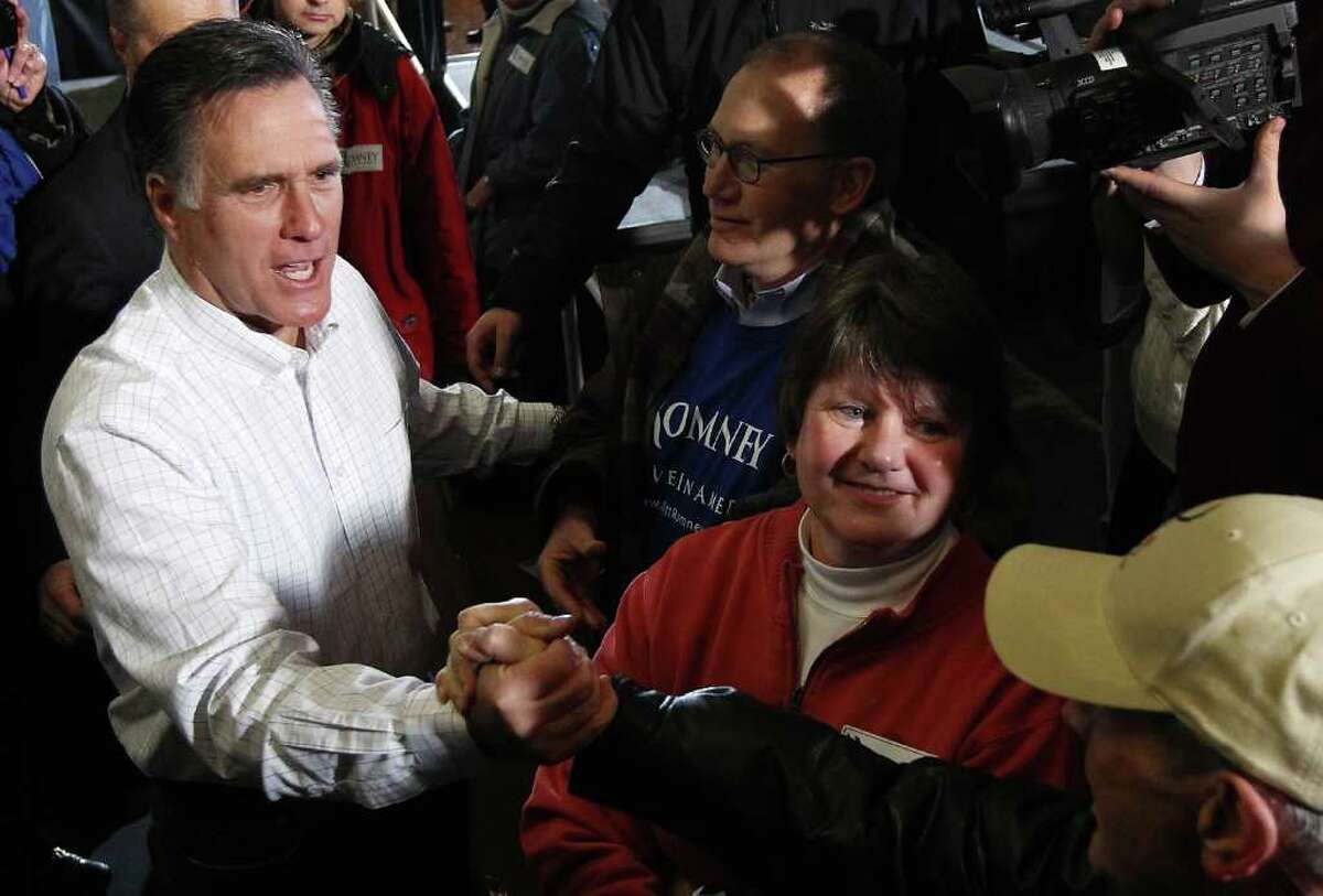 DAVENPORT, IA - JANUARY 02: Former Massachusetts governor and Republican presidential candidate Mitt Romney greets voters after speaking at a campaign event at the Mississippi Valley Fairgrounds January 2, 2012 in Davenport, Iowa. A poll published Saturday by the state's largest newspaper, The Des Moines Register, put Romney at the head of a large field of GOP candidates going into Tuesday's 'first in the nation' Iowa Caucuses. (Photo by Win McNamee/Getty Images)