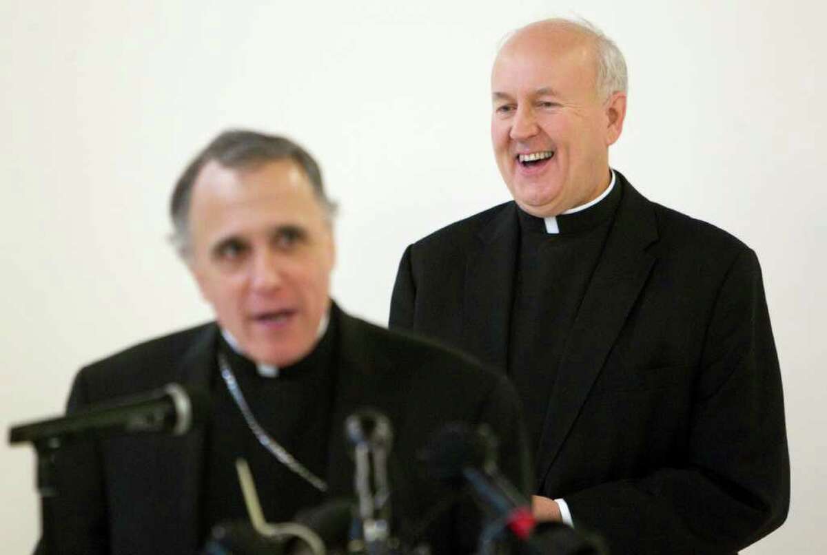 Rev. Jeffrey Steenson, right, a former Episcopal bishop who was named the Ordinariate Chair of Saint Peter by Pope Benedict XVI, laughs as Cardinal Daniel DiNardo addresses the media during a press conference about Steenson's appointment at Our Lady of Walsingham Catholic Church Monday, Jan. 2, 2012, in Houston. This is the second ordinariate in the world for former Anglican groups, which will be held at Our Lady of Walshingham parish. The fist was established to serve England and Wales. To date, more than 100 Anglican priests have applied to be ordained Catholic priests for the ordinariate. Fr. Steenson, who is married with three children, became Catholic in December 2007. ( Johnny Hanson / Houston Chronicle )