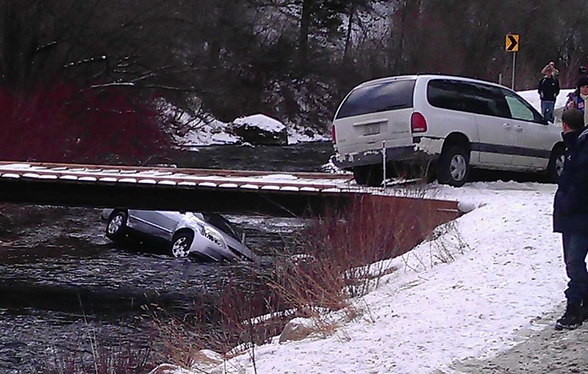 CORRECTS SPELLING OF WILLDEN THROUGHOUT -- A photo provided by Chris Willden shows a car in the Logan River in Utah Saturday Dec. 31, 2011, after the car was flipped upright by rescuers who saved three children trapped in the car. The car plunged off an embankment into the river and Willden shot out the car's window with a handgun and cut a seat belt to help free the children after the accident. (AP Photo/Chris Wilden)