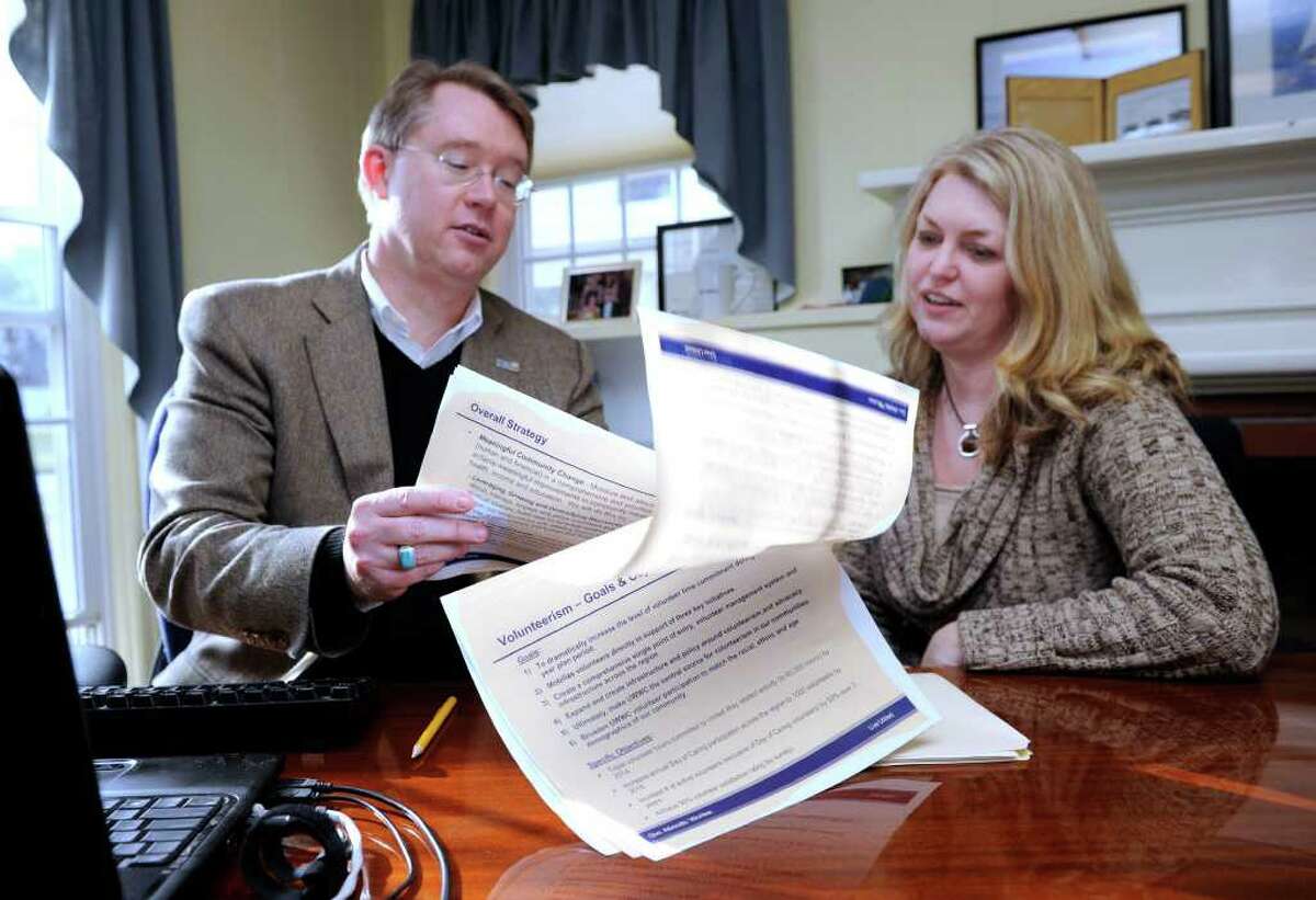 Michael Johnston, 51, left, outgoing CEO of The United Way of Western Connecticut, meets in his office with Kim Morgan, 44, who will replace him on an interim basis. Photo taken Tuesday, Jan. 3, 2012.